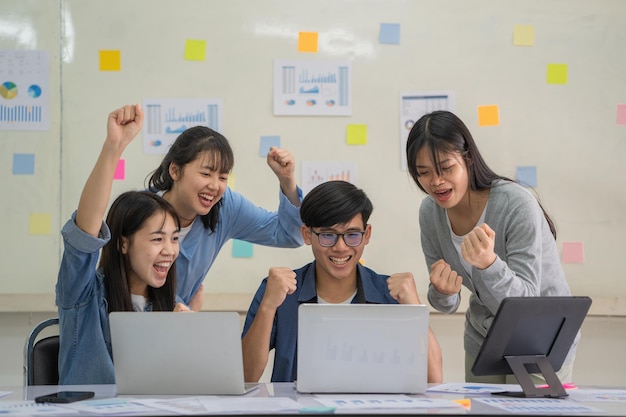 L'équipe d'affaires heureuse célèbre la victoire de l'entreprise.