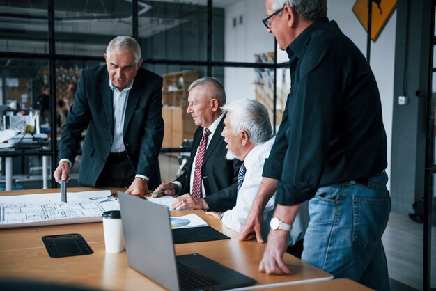 Une équipe âgée d'architectes d'affaires âgés a une réunion au bureau.