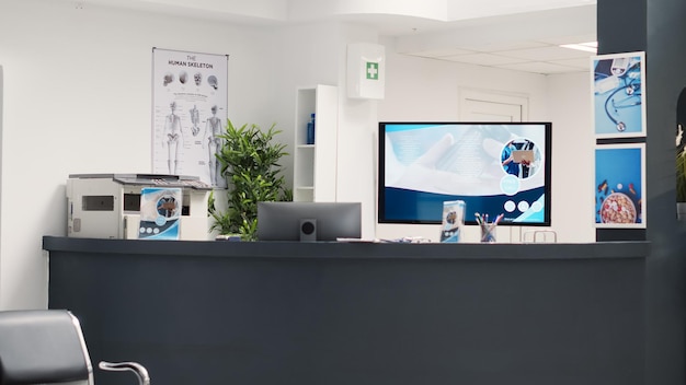 Espace médical vide et salle d'attente pour assister à un rendez-vous de visite de contrôle clinique au centre de diagnostic. Hall de l'hôpital avec ordinateur à la réception utilisé pour les formulaires d'inscription.