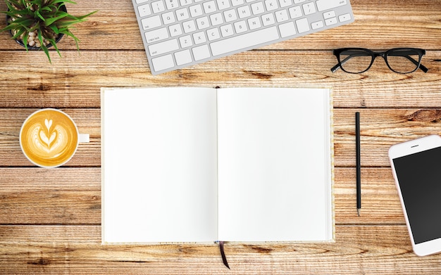 Espace de travail moderne avec tasse à café, smartphone, ordinateur portable et clavier sur bois