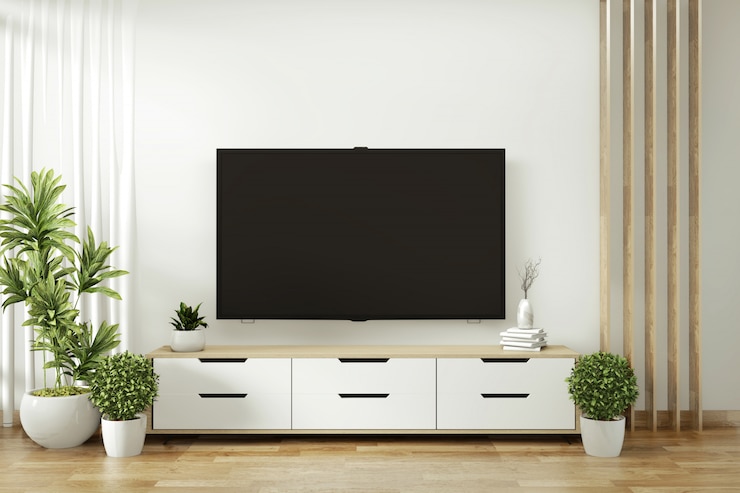 Photo étagère de télévision dans la salle vide moderne et les plantes de décoration sur le plancher de mur blanc en bois. rendu 3d