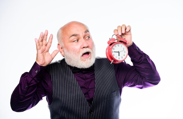 Photo Être en retard est une habitude gestion du temps entreprise démarrage retraite horloger ou réparateur de montres homme mûr avec barbe horloge montrer l'heure homme barbu mature avec réveil heure et âge chronométrage