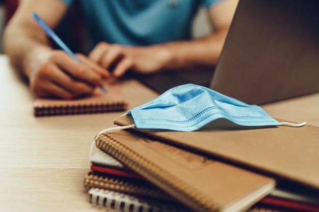 Un étudiant masculin étudie à la maison pendant la quarantaine