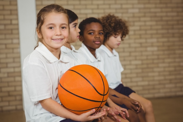 Étudiant Tenant Le Basket-ball Avec D'autres Joueurs