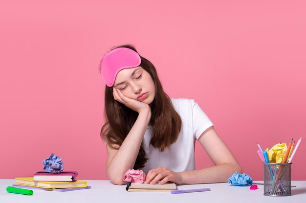 Une étudiante fatiguée s'est endormie en se préparant à l'examen et en faisant ses devoirs