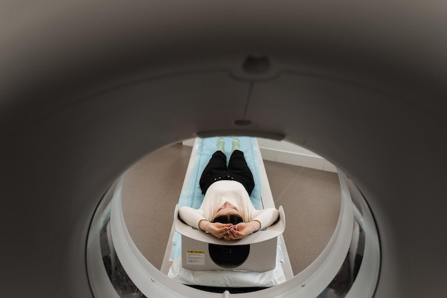 Examen CT xray du cancer du poumon dans une clinique médicale Une patiente allongée sur un lit de tomodensitométrie et des poumons de balayage pour diagnostiquer le cancer du poumon dans une clinique médicale