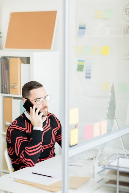 Expert en marketing beau sérieux parler au client au téléphone