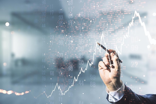 Exposition multiple de la main de l'homme avec un stylo travaillant avec un diagramme financier abstrait et une carte du monde sur fond de bureau flou concept bancaire et comptable