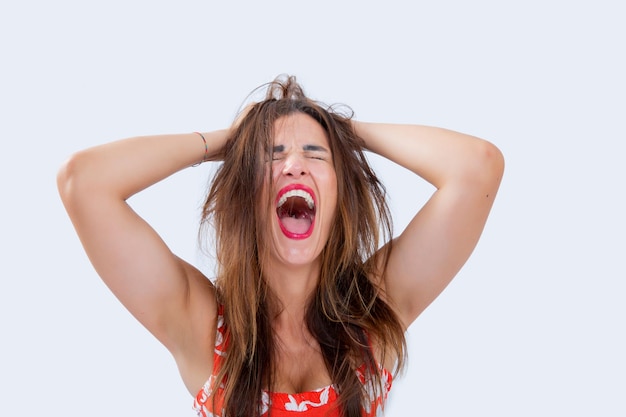 Expression de femme hystérique avec ses mains sur la tête