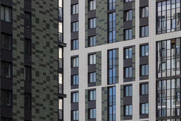 Façade d'un immeuble moderne avec fenêtres et carreaux en blanc vert et noir