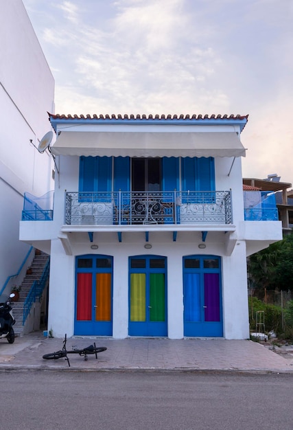 Façade d'une maison aux rideaux aux couleurs du drapeau LGBT dans la station balnéaire de Grèce