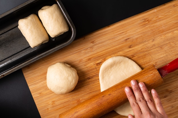 Faire du pain de pain de lait doux maison bio dans un moule à pain sur une planche en bois avec espace de copie