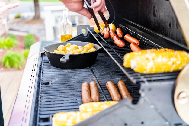 Faire frire de petites pommes de terre dorées dans une poêle en fonte sur un gril à gaz extérieur.