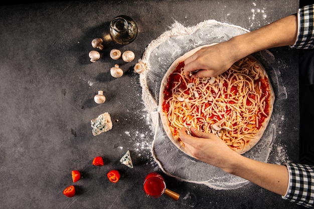 Photo faire une pizza avec des champignons sur la pâte