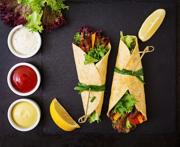 Fajitas mexicaines pour le boeuf et les légumes grillés (paprika, oignon rouge, tomate).