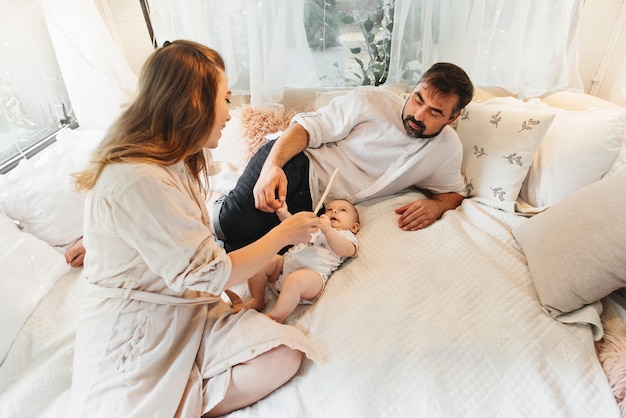 Famille avec bébé sur le lit dans la remorque le matin