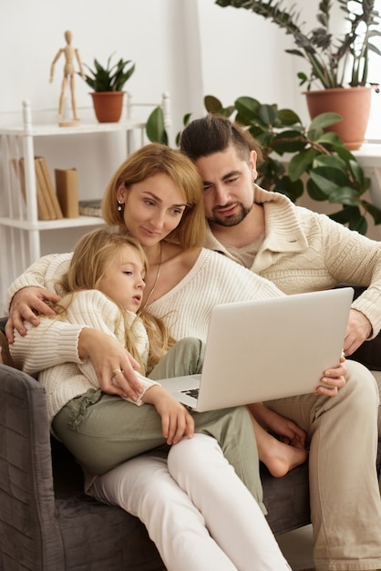 Famille avec bébé regardant un ordinateur portable