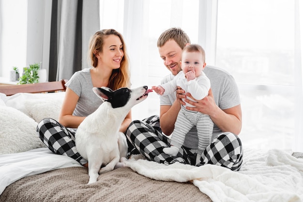 Famille avec chien dans le lit