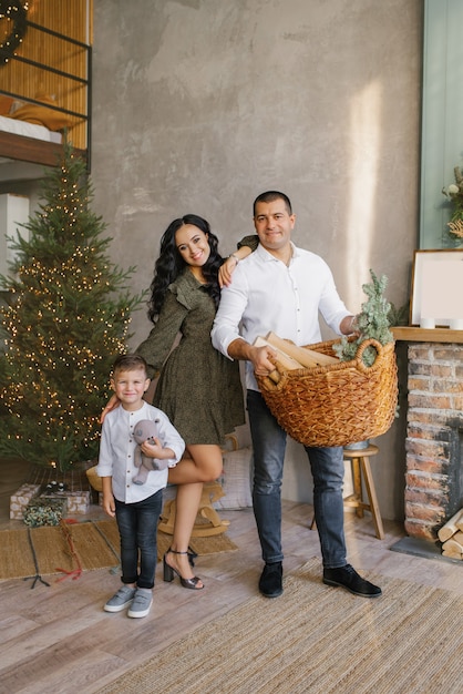 Une famille heureuse et élégante décore sa maison et se prépare pour la célébration de Noël