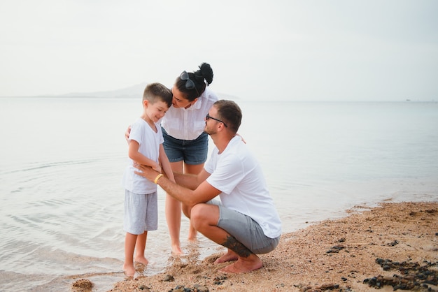 Famille heureuse marchant sur la plage