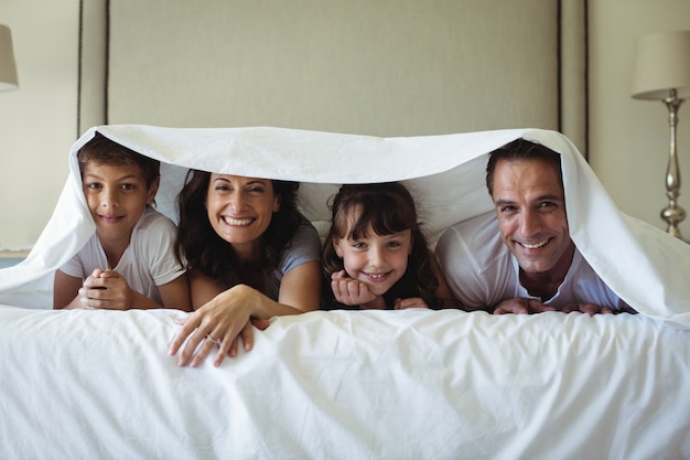 Famille heureuse, mensonge, sous, couverture, lit, chez soi