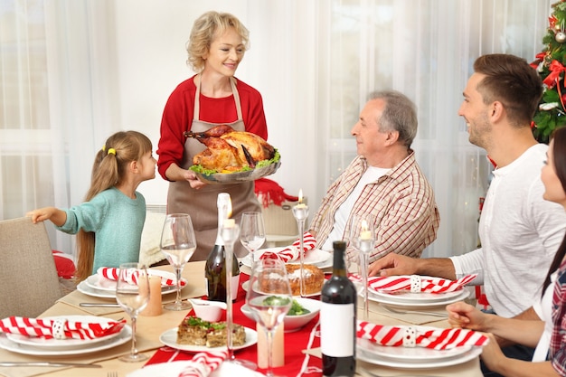 Famille heureuse en train de dîner de Noël dans le salon