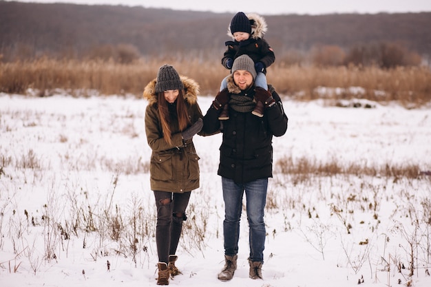 Famille en hiver dans la forêt avec fils