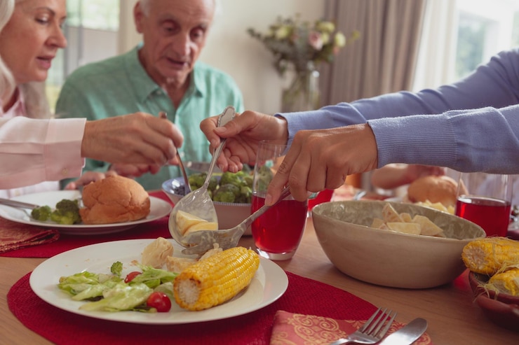 Photo la famille mange sur la table à manger à la maison