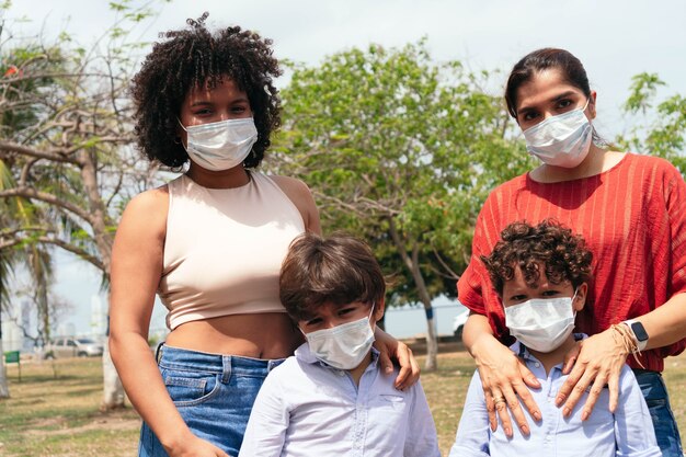 Photo famille avec masque de protection dans le parc