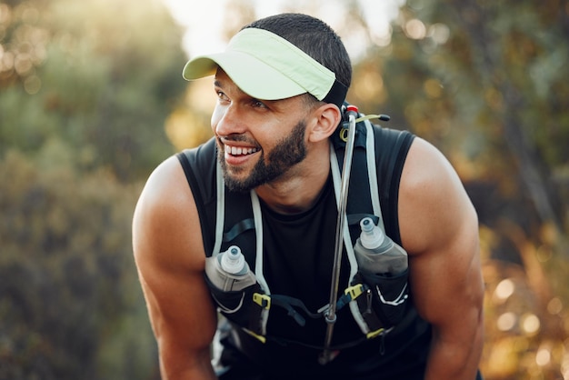 Fatigué heureux et homme pensant après l'entraînement physique pour le bien-être cardio et l'objectif corporel dans la nature Athlète coureur respirant après avoir couru faire de l'exercice sportif et s'entraîner pour la santé dans un parc