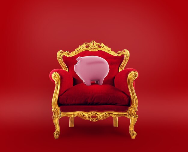 Fauteuil confortable rouge et doré avec une tirelire. Concept comme premier service d'épargne