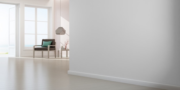 Fauteuil sur plancher en bois avec fenêtre et mur en béton rose dans un grand salon à la nouvelle maison moderne.