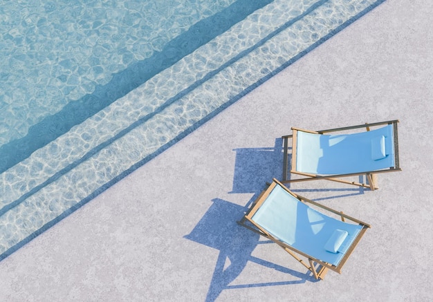 Des fauteuils au bord de la piscine sur un sol en béton