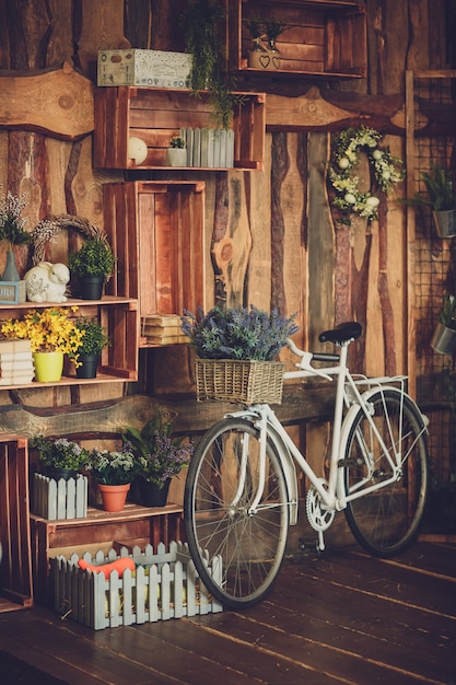 Faux fleurs en plastique dans un panier sur un vélo rétro blanc