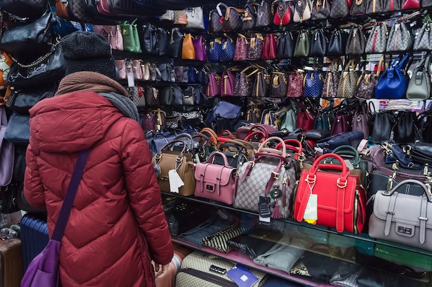 Une femme achète un sac à main