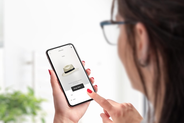 Femme acheter un chapeau en ligne Concept de magasinage en ligne avec téléphone intelligent Application de commerce électronique moderne avec un design plat