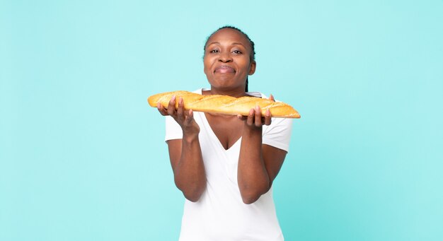 Femme adulte afro-américaine noire tenant une baguette