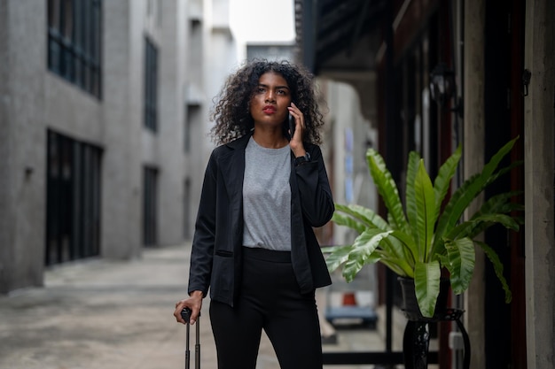 Femme d'affaires africaine ayant un style lifr à l'espace piétonnier extérieur