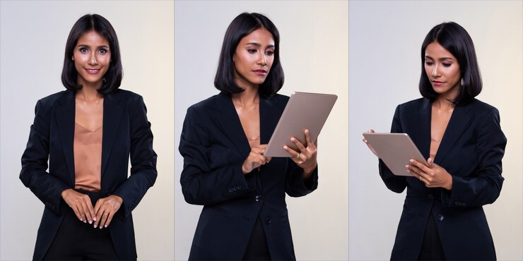 Une femme d'affaires arabe indienne se tient dans un pantalon et des chaussures de costume formel, un éclairage de studio sur fond blanc isolé, le patron de l'avocat agit à l'aide d'une tablette numérique comme communication de travail