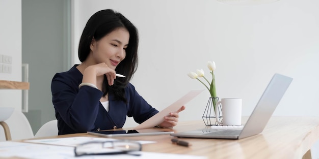 Femme d'affaires asiatique travaillant au bureau avec des documents de travail