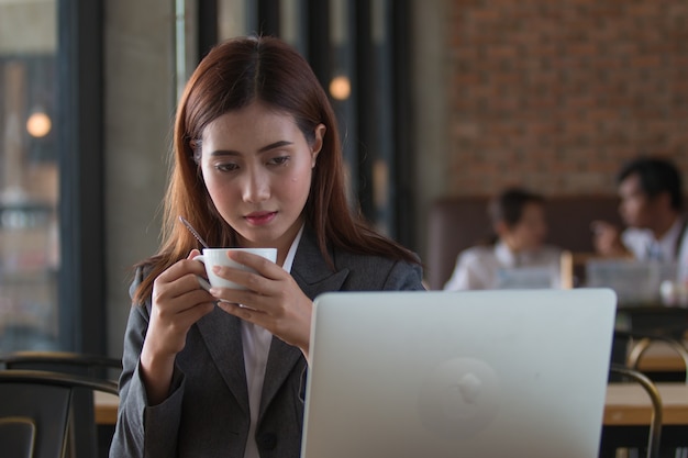 Femme d&#39;affaires asiatique travaillant dans un café