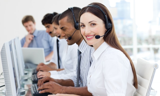 Femme d&#39;affaires avec casque en souriant à la caméra