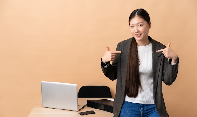 Femme d'affaires chinoise dans son lieu de travail fière et satisfaite d'elle-même