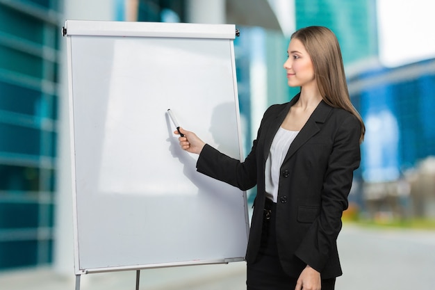 Femme d'affaires expliquer au tableau blanc