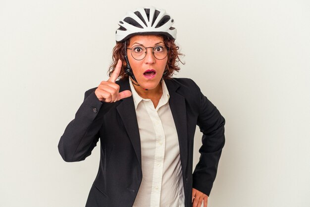 Femme d'affaires latine d'âge moyen portant un casque de vélo isolé sur fond blanc ayant une idée, un concept d'inspiration.