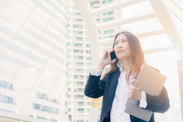 La femme d&#39;affaires parle au téléphone: concept extérieur