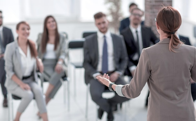 La femme d'affaires tient un briefing pour des employés