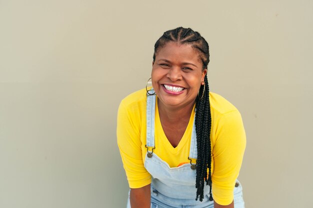 Femme afro-américaine avec des tresses en regardant la caméra