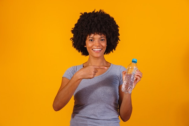 Femme afro avec une bouteille d'eau