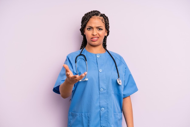 femme afro noire qui a l'air en colère, agacée et frustrée. notion d'infirmière